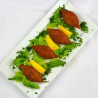 Fried Kebbeh · Fine ground beef stuffed with seasoned meat, spices, and deep fried to perfection.