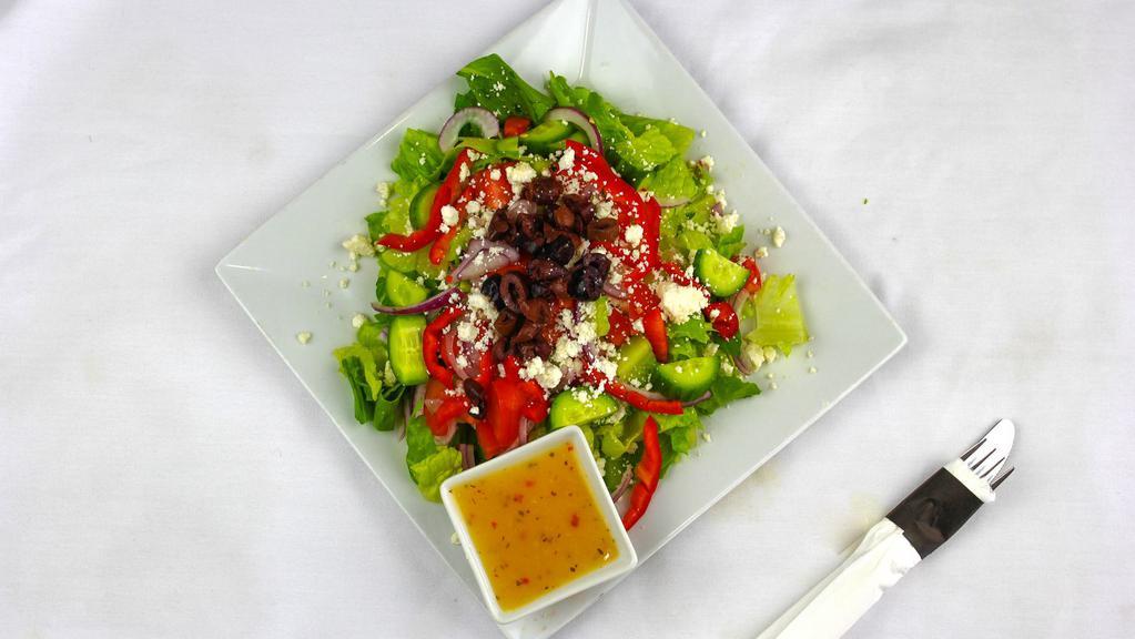 Greek Salad · Lettuce, tomatoes, red onions, bell pepper, and cucumbers tossed with our house Greek salad dressing, topped with Greek feta and olives.