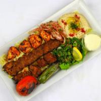 Combo Kebab Plate · A combination of chicken, beef, and lule skewers, served with rice, hummus, tabbouleh, tomat...