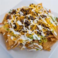 Nachos W/ Choice Of Meat · Choice of Meat, Our Tortilla Chips, Beans, Pico de Gallo, Sour Cream, Guacamole, and Cheese.