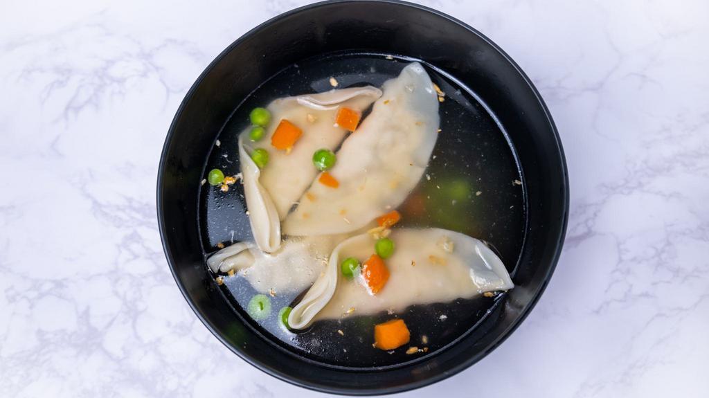 Wonton Soup · Chicken wonton soup with pea and carrot, bok choy and topped with cilantro in clear chicken broth.