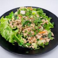 Chicken Larb Salad · Pan fried minced chicken tossed with onion, mint leaves, rice powder and cilantro in lime dr...