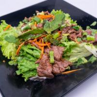 Beef Salad · Sliced grilled juicy steak tossed with red onion, green onion, mint leaves, cilantro, roaste...