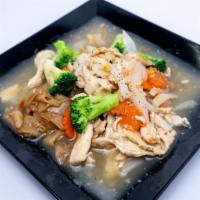 Rad Nar · Pan fried flat rice noodle topped in homemade gravy brown sauce with broccoli and carrot. Ad...