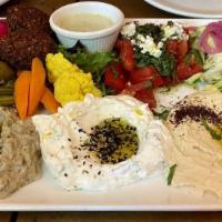 Mezza Platter · Hummus, lebne, baba ghanoush, falafel, cabbage salad, pickled vegetables, marinated olives, ...