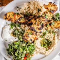 Chicken Kabob · Marinated in yogurt, saffron, and spices. Grilled and served with lebne, hummus, tabbouleh s...