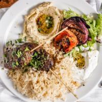 Kefta Kabob · Ground spiced beef and lamb skewers. Grilled and served with rice, lebne, hummus, tomato, an...