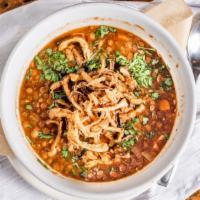 Seasonal Soup - Harira · Vegan. Vegan lentil soup with crispy onions on top.