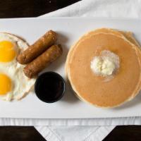 Buttermilk Pancakes · Two golden brown pancakes served with two eggs and your choice of bacon or sausage links.