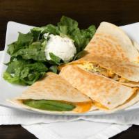 Breakfast Quesadilla · Scrambled eggs, sausage, pico de gallo, avocado, mixed jack, and cheddar cheese, garnished w...