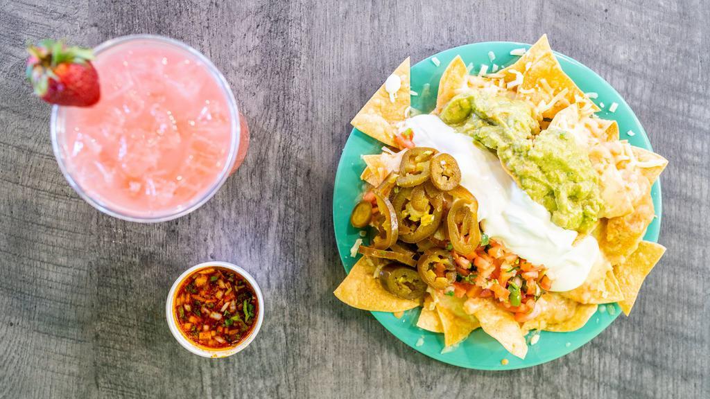 Super Nachos · Meat, chips, melted cheese, refried beans, guacamole, pico de gallo, sour cream, jalepenos.