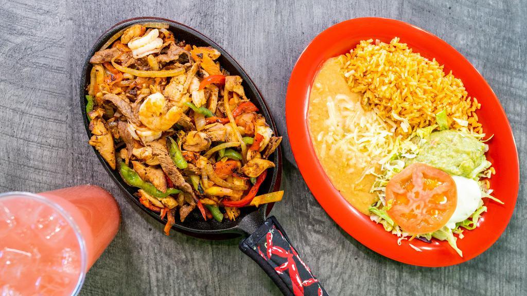 Fajitas Cielo Mar Y Tierra · Chicken, beef strips and shrimp with green bell peppers, tomatoes, onions. Served with rice and beans, cheese, sour cream lettuce, guacamole, pico de gallo and tortillas.