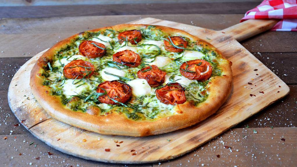 Margherita Pizza · Fresh mozzarella and Parmesan cheese, roasted tomatoes, shredded basil leaves and pesto sauce.