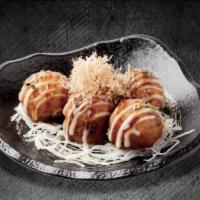 Takoyaki · Grilled octopus battered and fried, served with dynamite mayonnaise, smokey takoyaki sauce, ...