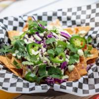 Vegan Loaded Nachos · vegan chili, vegan white cheddar, green onion, cabbage, tofu ‘sourcream' + jalapeno