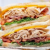 The Roxbury Sandwich · turkey club, cheddar, bacon, tomato, arugula, lemon herb aioli, rustic sourdough