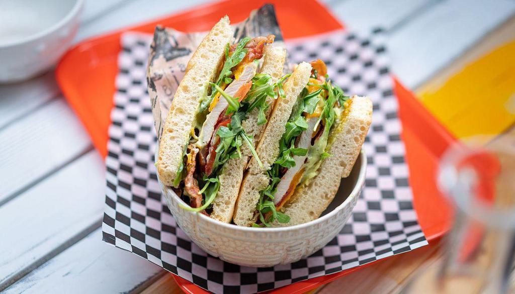 Grilled Chicken Sandwich · grilled chicken with cheddar, nitrate free bacon, arugula, tomato, tarragon mayo, served on homemade focaccia