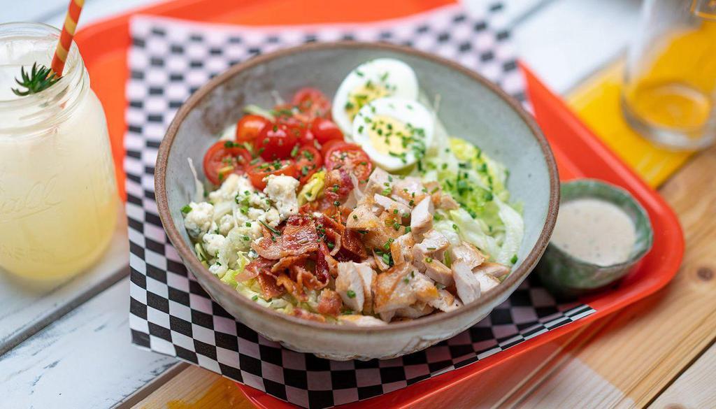 Cobb Iceberg Lettuce Wedge · grilled chicken, tomatoes, blue cheese crumbles, bacon, chives, egg, blue cheese dressing (on the side)