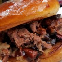 Brisket Sandwich · Slow and smoked brisket topped with BBQ sauce on a Brioche bun.