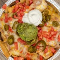 Nachos · Chips, ranchero sauce, refried beans, cheese, and tomatoes. Topped with sour cream, fresh gu...