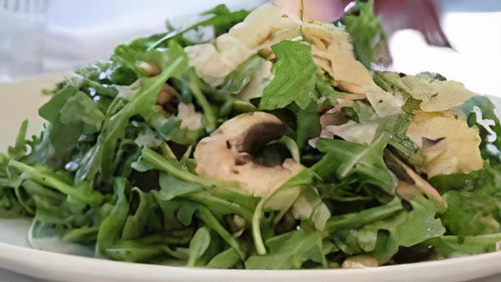 Arugula Salad · Gluten-free. Baby organic arugula, thinly sliced mushrooms, and shaved parmigiano with citronette.