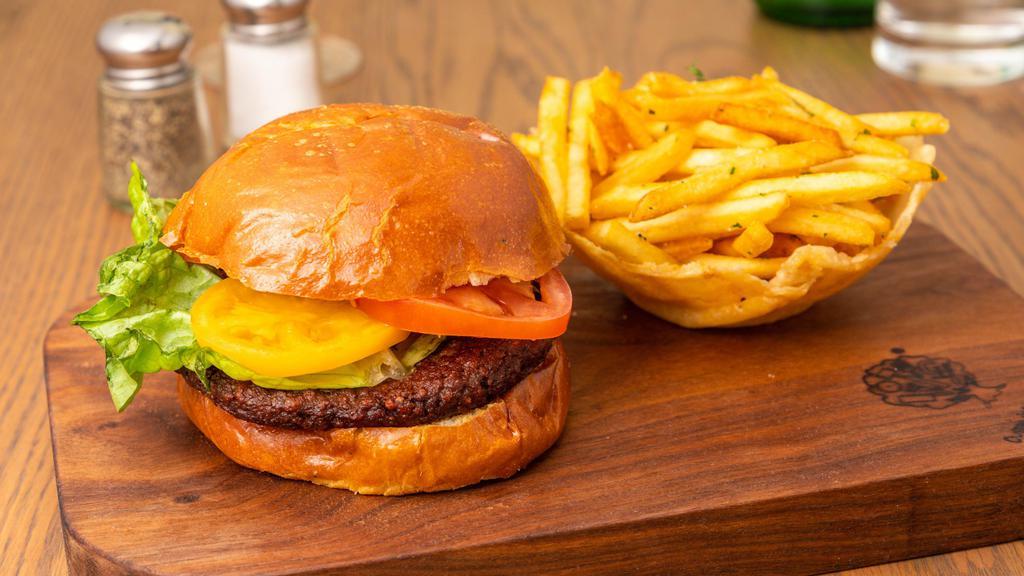 ‘Impossible’ Burger · Vegan. Plant-based vegan burger, lettuce, tomato, and avocado spread on Puritan vegan bun with french fries.