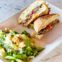 Steak Sandwich · Steak Sandwich
Thinly sliced steak, mushrooms, roasted red peppers, onions and Mozzarella on...
