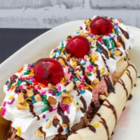 Banana Split · Three scoops of ice cream, banana, whipped cream, nuts, sprinkles, syrup drizzle and a cherr...