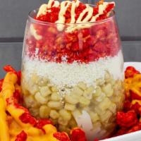 Flaming Corn · A cup of corn with mayo, Cheetos, butter on top of a plate of hot Cheetos with nacho cheese.