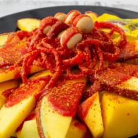 Chamimango Mango · Wrapped in a spicy candy, peanuts, tamarind candy, salsaghetti spicy candy, chamoy, and tajin.