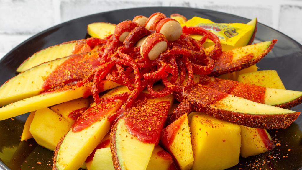 Chamimango Mango · Wrapped in a spicy candy, peanuts, tamarind candy, salsaghetti spicy candy, chamoy, and tajin.