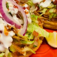Two Handmade Sopes · Chosse of pork, chicken, or beef, served with lettuce, sour cream, rice, and beans.