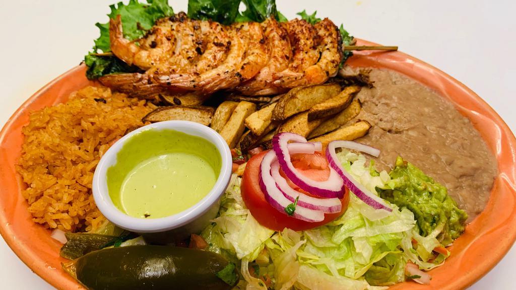 Camarones A La Plancha · Grilled jumbo shrimp served with rice, beans, salad, French fries, and guacamole.