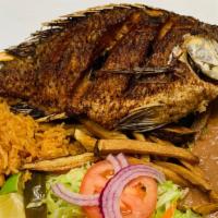 Mojarra Frita · Whole cut fish, deep fried served with beans, salad, French fries, and guacamole.