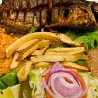 Pescado Frito · Whole cut fish, deep fried served with beans, salad, French fries, and guacamole.