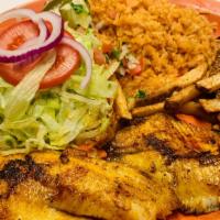 Filete De Tilapia · Tilapia fillet served with rice, salad, and French fries.