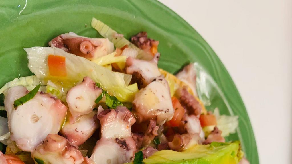 Tostada De Pulpo · Tostada with diced tomatoes, onion, and cucumber octopus.