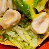 Tostada De Abalone · Tostada with diced tomatoes, onion, and cucumber abalone fish.