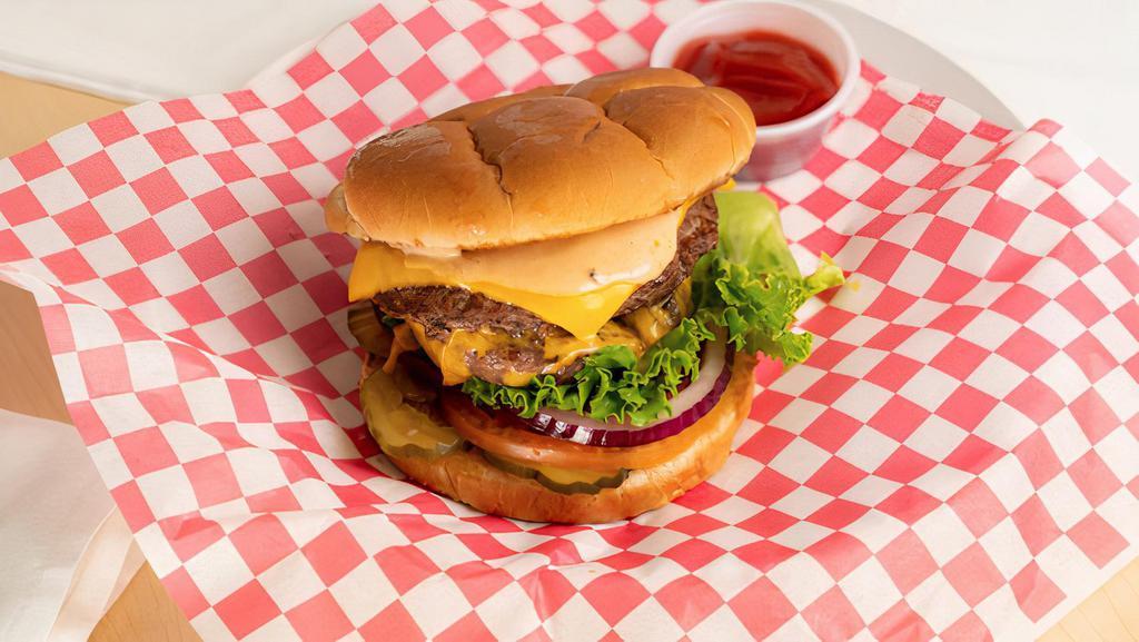 Double Burger Combo · 2x 1/4 lb. Fresh Beef Patties, Lettuce, Onion, Tomato, Pickles, American Cheese, and House-Made Thousand Island Dressing. Includes Fresh Cut Fries and a regular fountain drink.