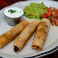 Taquitos Rancheros · Three pulled beef or chicken rolled in crisp corn tortillas. Topped with guacamole, pico De ...