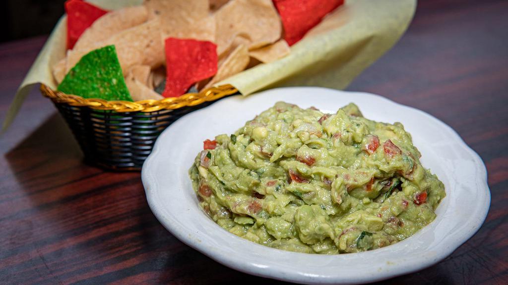Guacamole Dip · Fresh avocados combined with spices, onions and tomatoes. Served with tortilla chips.