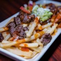 Carne Asada Fries · French fries with carne asada in red chile sauce. Served with pico De gallo, cheese, guacamo...