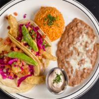 2 Piece Fish Tacos Combo · Soft corn tortillas stuffed with seasoned battered fried or grilled fish. Topped with red ca...