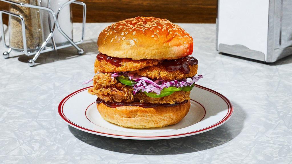 The Best Bbq In Town Fried Chicken Sandwich · Our signature fried chicken served on a toasted bun and topped with deep fried onion rings, jalapeno, red cabbage slaw, and barbecue sauce.