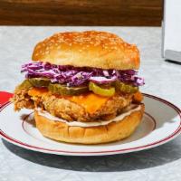 The Og With Cheese Fried Chicken Sandwich · Our signature fried chicken served on a toasted bun and topped with coleslaw, cheddar cheese...