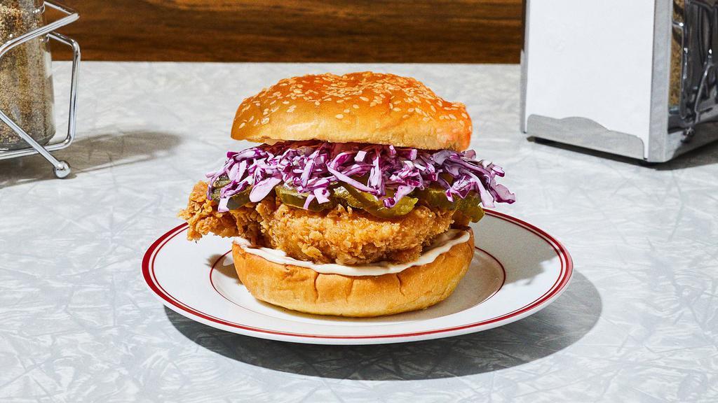 The Og Fried Chicken Sandwich · Our signature fried chicken served on a toasted bun and topped with red cabbage slaw, pickles, and mayo.
