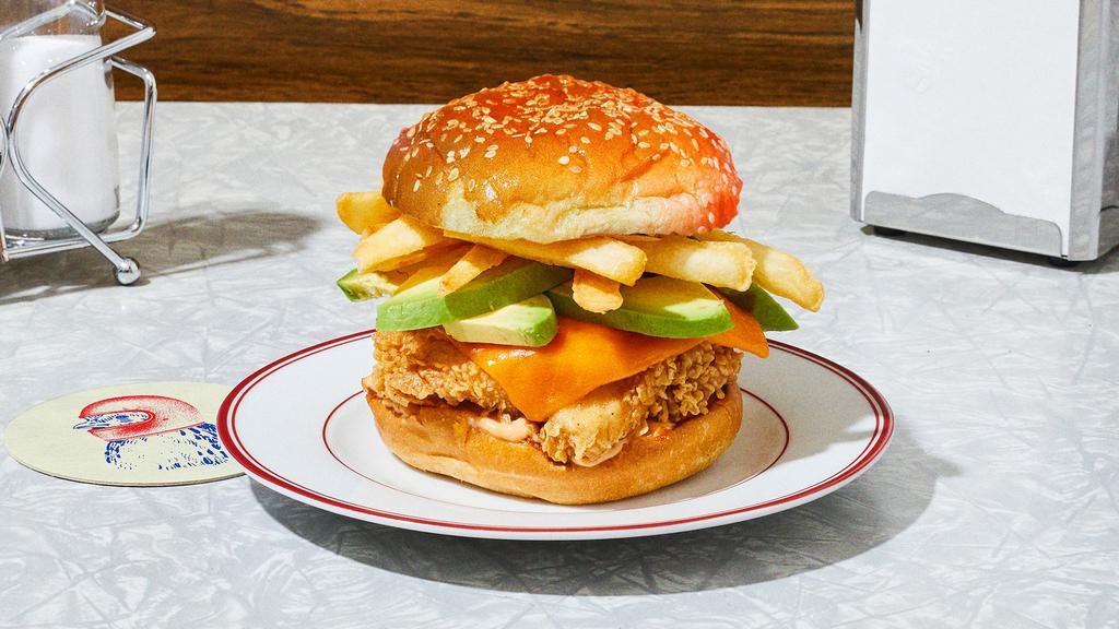 The Classic Californian Fried Chicken Sandwich · Our signature fried chicken served on a toasted bun and topped with cheddar cheese, avocado, chipotle aioli, and french fries.