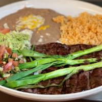 Carne Asada · Tender beef served with rice and beans, tomatillo sauce, guacamole salad and two tortillas.