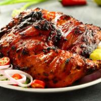 Tandoori Chicken · Skinless chicken legs and breast that has been marinated in yogurt with spices and barbequed.