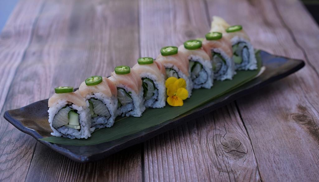 Yellowtail Cilantro Roll · Yellowtail, cucumber, cilantro topped with yellowtail and serrano peppers. Served with ponzu sauce.